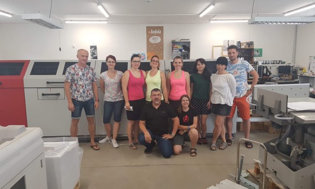 Computer MCL team in front of Photobook binding equipment