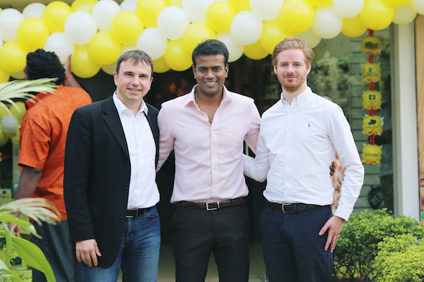 3 men standing in front of yellow balloons